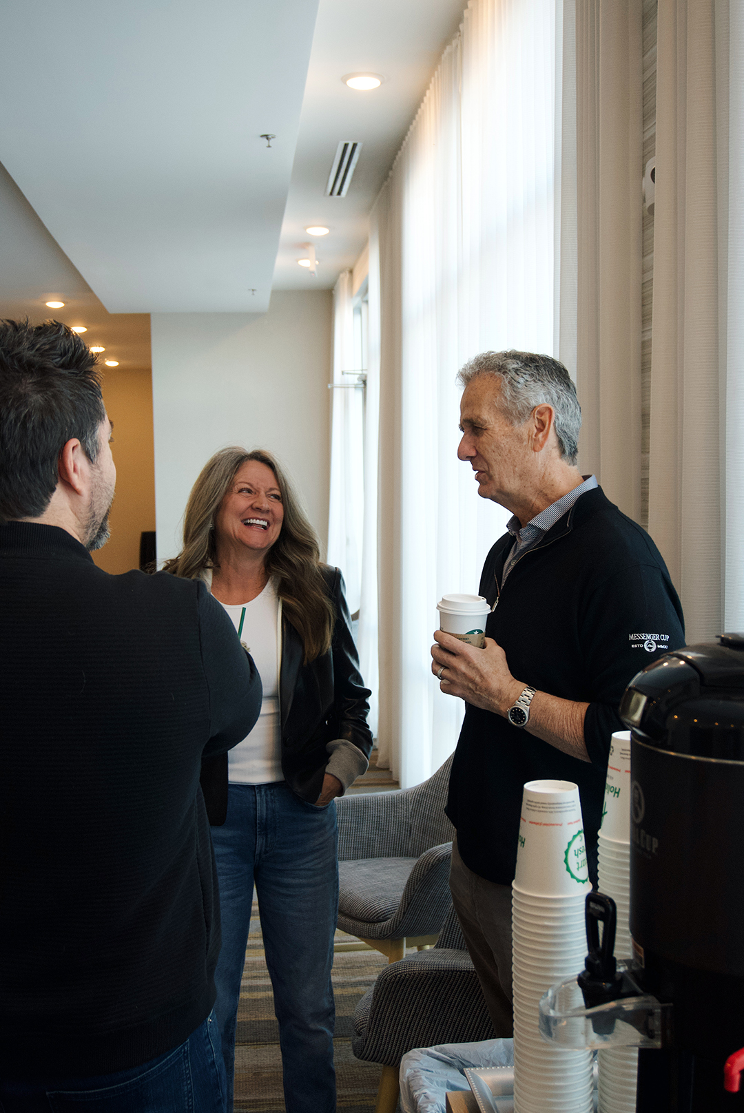 Church members serving and welcoming one another over coffee
